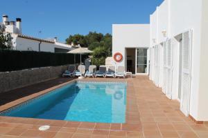 a swimming pool in the backyard of a house at Villa ELENA, Cala'n Bruc in Cala en Blanes
