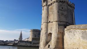 een groot kasteel met een toren bovenop een gebouw bij gîte les petits poissons verts et massages in La Jarrie