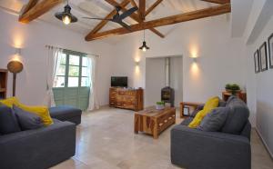 a living room with two blue couches and a table at Villa Aquilo in Megali Ammos
