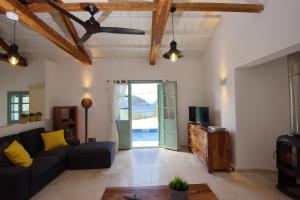 a living room with a couch and a tv at Villa Aquilo in Megali Ammos