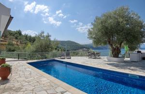 a swimming pool with a view of the water at Villa Aquilo in Megali Ammos