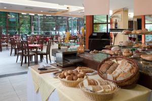 a bakery with a table with baskets of bread at Hotel Arabella Beach in Albena