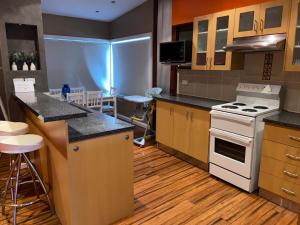 a kitchen with a stove and a counter top at Blacksmiths Beach Shack in Blacksmiths