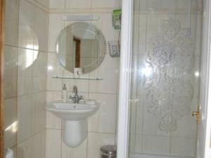une salle de bain avec un lavabo et un miroir dans l'établissement 1-Bed Cottage on Coastal Pathway in South Wales, à Gileston 17 autres photos