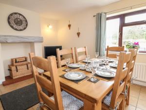 - une salle à manger avec une table et des chaises en bois dans l'établissement The Lodge, à Belper