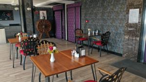 a restaurant with tables and chairs in a room at ERDEM HOTEL in Antalya