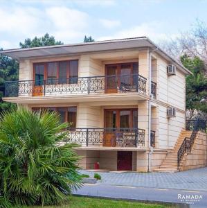 a large house with a balcony on the side of it at Ramada by Wyndham Baku in Baku