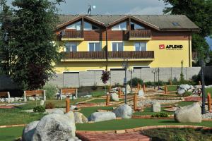 a building with a garden with rocks in front of it at APLEND Tatry Holiday in Veľký Slavkov