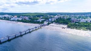an aerial view of a beach with a bridge at Rewita Międzyzdroje Neptun in Międzyzdroje