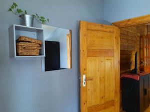 a room with a wooden door and a wall at Apartment Uliha in Liepāja