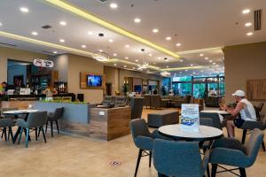a lobby with tables and chairs and a restaurant at Viking Park Hotel in Kemer