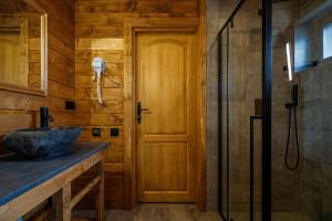 a bathroom with a sink and a shower at Szałas "Jodłowe Izby" in Białka Tatrzanska +41 photos