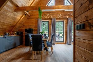 a kitchen and dining room with a table and chairs at Szałas "Jodłowe Izby" in Białka Tatrzanska
