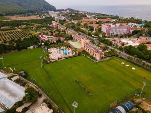 an aerial view of a campus with a large green field at Viking Park Hotel in Kemer