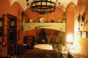 sala de estar con lámpara de araña y chimenea en Casa Rural El Aguila, en Montemolín