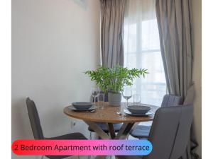 a dining room table with chairs and a table with wine glasses at Stylish 2BR with fantastic ocean views and WiFi in Costa Adeje in Callao Salvaje