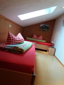 a bedroom with two beds and a skylight at Ferienwohnung Dopfer in Eisenberg