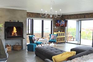 a living room with a couch and a fireplace at Kleinmond - Fairview on First in Kleinmond