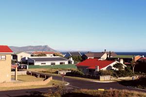 a suburb with houses and the ocean in the background at Kleinmond - Fairview on First in Kleinmond