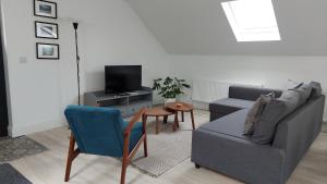 a living room with a couch and a chair at Finn Loft in Ballybofey