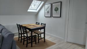 a dining room table with chairs and a window at Finn Loft in Ballybofey