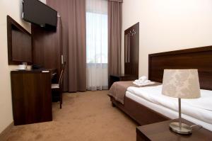 Łóżko lub łóżka w pokoju w obiekcie Hotel Forum Fitness Spa & Wellness