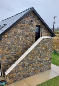 a small brick building with a staircase in it at Finn Loft in Ballybofey