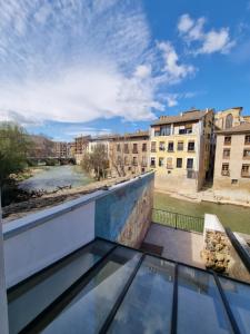 a balcony with a view of a river and buildings at Hostal La Rúa in Estella