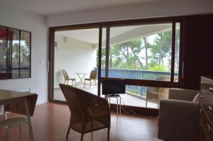 a living room with a large sliding glass door at Appartement Pour 2 Personnes Vue Sur Le Port- Residence Jean Rameau in Hossegor