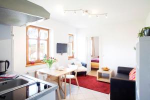 cocina y sala de estar con mesa y sofá en Das Landhaus, en Mainleus