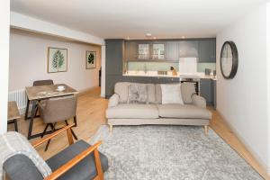 a living room with a couch and a table at The Burrow by Harrogate Serviced Apartments in Harrogate