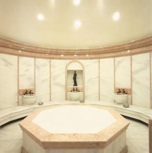 a large room with three sinks and a large tub at Occidental Taksim in Istanbul