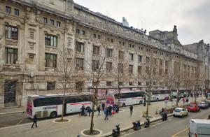 a city street with buses parked in front of a building at CSI Group - Hotel Central Station in Milan