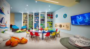 a childrens room with a table and chairs at Valamar Diamant Residence in Poreč
