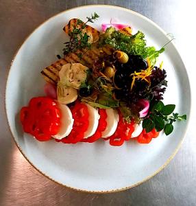 a plate of food with vegetables on a table at Hotel Venecia Palace in Michałowice