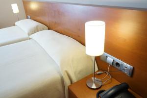 A bed or beds in a room at Hotel Santuari Balaguer