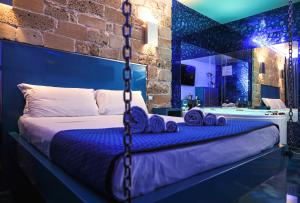 a master bedroom with a bed with blue walls at Villa Asfodelo Guest House & Relax in Alghero