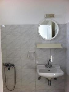 a bathroom with a sink and a mirror at Studios Vagos 2 in Agios Prokopios