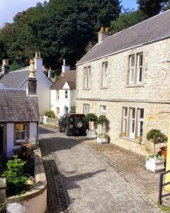 a group of houses with a car parked in the street at stay bed and breakfast in Culross