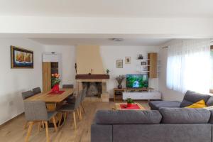 a living room with a couch and a table at Apartmani Ravan in Cernik