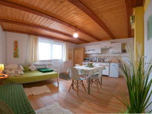 a kitchen and living room with a table and a couch at U Synowców in Polańczyk