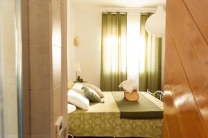 a bedroom with a bed with green curtains at PURA B&b in Noicattaro