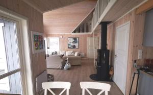 a room with a living room with a stove at Cabin Panorama Lofoten with Jacuzzi Magic view in Offersøya