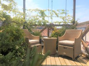 three wicker chairs sitting on a wooden deck at Ca' San Giorgio B&B in Venice