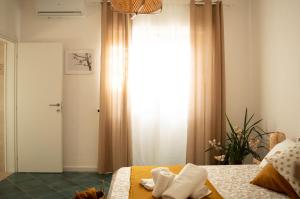 a bedroom with a bed with towels on it at PURA B&b in Noicattaro