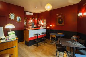 a restaurant with red walls and tables and chairs at Casa Ortega in Marseille