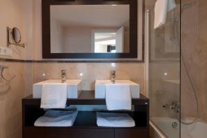La salle de bains est pourvue de 2 lavabos et d'un miroir. dans l'établissement Apartamento vista mar frontal garaje y WiFi, à Torrox Costa