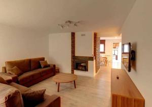a living room with a couch and a fireplace at El Mirador de Candelario in Candelario