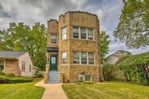 a tall brick building with a green door at Chicago Family Apartment - Kids and Pets Welcome! in Evanston