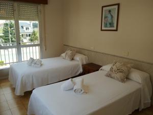 Postel nebo postele na pokoji v ubytování CASA PORTELA APARTAMENTOS